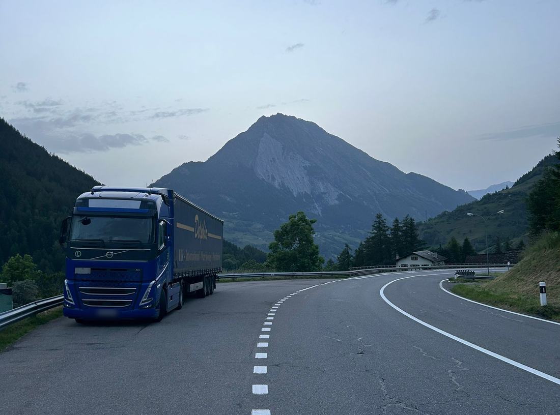 Delphic outfit climbing an alpine road on the run to Italy
